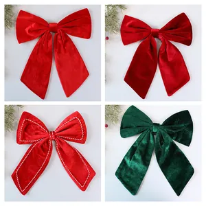 Detailed view of large red and green velvet Christmas bows for tree decoration