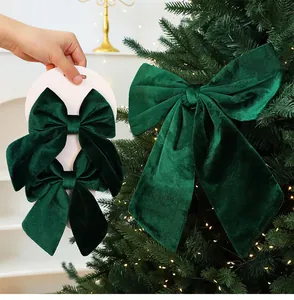 Detailed view showing a large dark green velvet Christmas bow and small set on a card