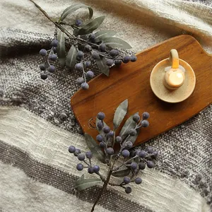 Artificial blueberry sprigs and faux foliage for Christmas tree and wreath decoration
