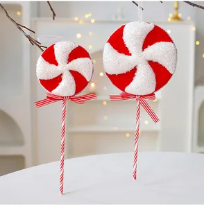 Close-up view of red and white glittery foam lollipop Christmas tree ornaments