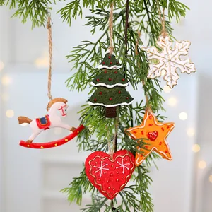 Vintage Christmas resin ornaments with snowflake, heart, tree, and star shapes on pine.