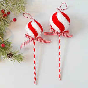 Detailed view of red and white striped foam lollipop Christmas tree ornaments with glitter.