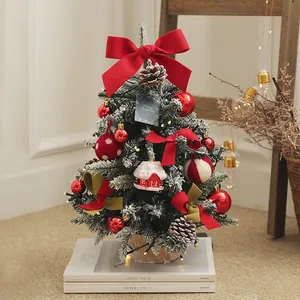 Tabletop Christmas tree with red and white DIY decorations and warm LED lights