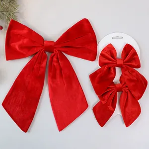 Detail of large and medium red velvet bows for Christmas tree decoration with packaging