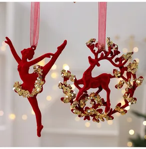 Detail of burgundy flocked ballerina and reindeer Christmas tree ornaments with gold sequins