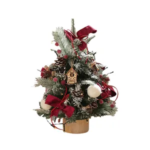 Desktop mini Christmas tree with red berries, pine cones, and velvet bows decor