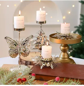 Eine Gruppe festlicher Weihnachts-Kerzenhalter aus Metall mit Schmetterlings-Motiv