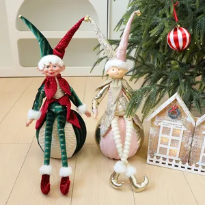 Zwei festliche Weihnachts-Elfpuppen-Ornamente auf großen dekorativen Kugeln zur Dekoration.