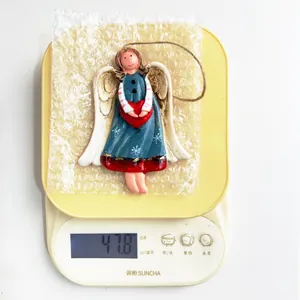 Detailed weight measurement view of retro resin angel hanging ornament showing 47.8 grams