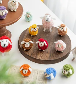 Handmade wool felt sheep figurines in various colors for festive Christmas table decor