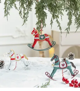 Detailed view of vintage metal rocking horse Christmas tree ornaments in festive snowy setting