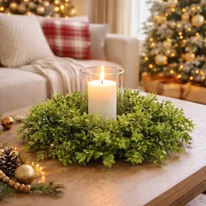 Elegant artificial boxwood wreath centerpiece decoration featuring a white candle