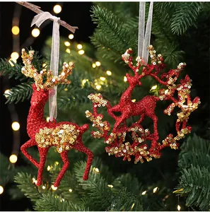 Detailed view of red glitter reindeer ornaments with gold sequins for Christmas tree.