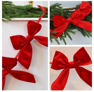 Detail showing red velvet bows on a Christmas garland banner for festive decoration.
