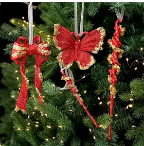 Detail of red glitter Christmas tree ornaments with gold sequins and warm lights