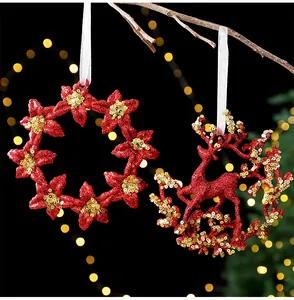 Detailed view of red glitter floral wreath and reindeer Christmas ornaments with gold sequins