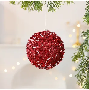 Détail d'une boule de Noël rouge festive de 10 cm avec paillettes et perles blanches