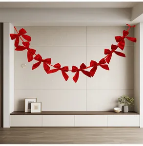 Red bow garland banner hanging on wall for festive Christmas home interior decoration