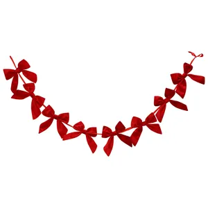 Red velvet bow garland bunting for Christmas tree and window festive decoration.
