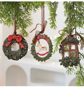 Set of three vintage resin Christmas tree ornaments hanging on evergreen pine branches