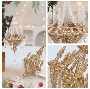 Close-up detail of a gold glitter chandelier Christmas ornament with elegant crystal drops.