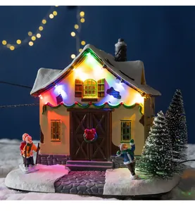 Detailed macro view of a festive Christmas cottage with colorful glowing LED lights