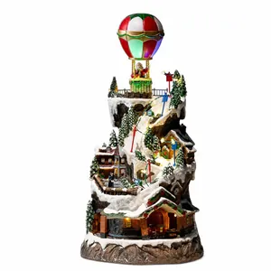 Festive Christmas snow village mountain with rotating train and Santa hot air balloon decoration