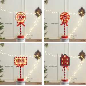 Close-up detail of four festive Christmas wooden LED signs with size and weight specs