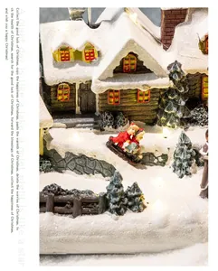 Detailed view of resin Christmas village house with warm LED lights and figurines