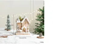Close-up detail of glowing Nordic wooden Christmas house with faux snow decoration