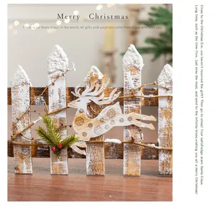 Detailed view of a Nordic style wooden Christmas fence with a carved reindeer ornament.