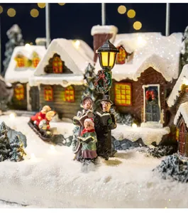 Macro view of detailed resin Christmas village featuring carolers and warm LED lights