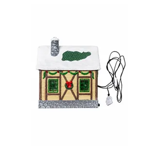 Exquisite Christmas miniature village house with snow-covered roof and integrated lights