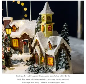 Close-up of a festive resin Christmas snow village with glowing street lamp and carolers