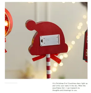 Detailed back view of wooden Santa hat LED ornament showing battery box and switch