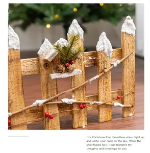 Close-up of rustic wooden Christmas fence with artificial snow and red berries