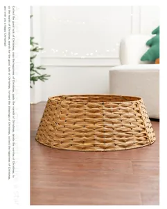 Hand-woven wicker Christmas tree collar skirt for holiday home decor in warm setting.