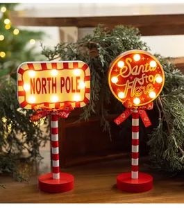 Festive wooden LED Christmas road sign ornaments with Santa Stop Here and North Pole motifs