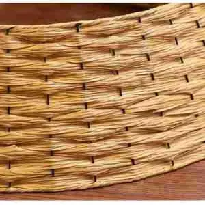 Macro detail of hand-woven straw texture on a Nordic Christmas tree base cover skirt.