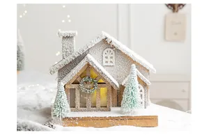 Detailed close-up of a rustic wooden Christmas house with artificial snow and warm lights