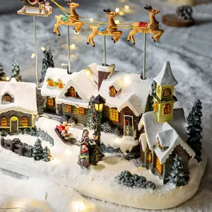 Hand-painted resin Christmas village decoration with flying reindeer and warm LED lights