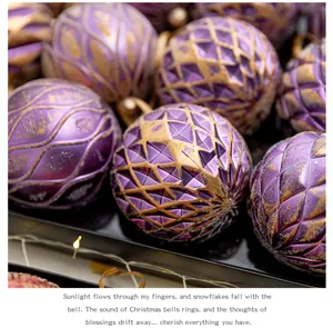 Close-up detail of purple and gold textured Christmas ornaments with carved patterns