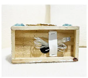 Bottom view of wooden Christmas house showing the USB power cable and internal structure