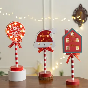 Set of three decorative wooden Christmas LED signs with Santa Stop Here text.
