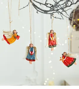 Detailed view of four vintage hand-painted resin angel ornaments with hearts and stars