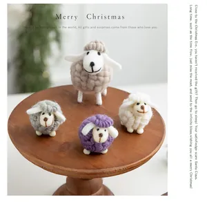 Hand-made wool felt sheep Christmas ornaments in various sizes on a wooden stand.