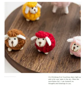 Detailed macro view of handmade wool felt sheep ornaments for festive Christmas desktop decor