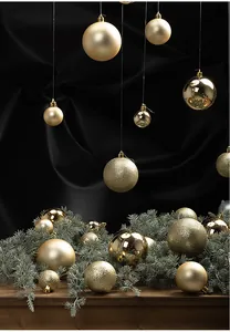 Detail of luxury golden Christmas ornaments in matte and glitter finishes on pine branches