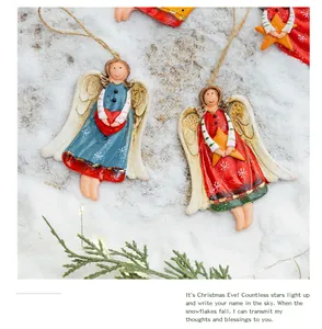 Detail of vintage hand-painted resin angel ornaments with heart and star motifs