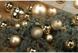 Detailed view of gold Christmas ball ornaments with matte, glossy, and glitter finishes